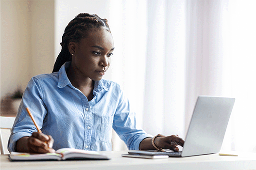 woman staring at a laptop working on a project